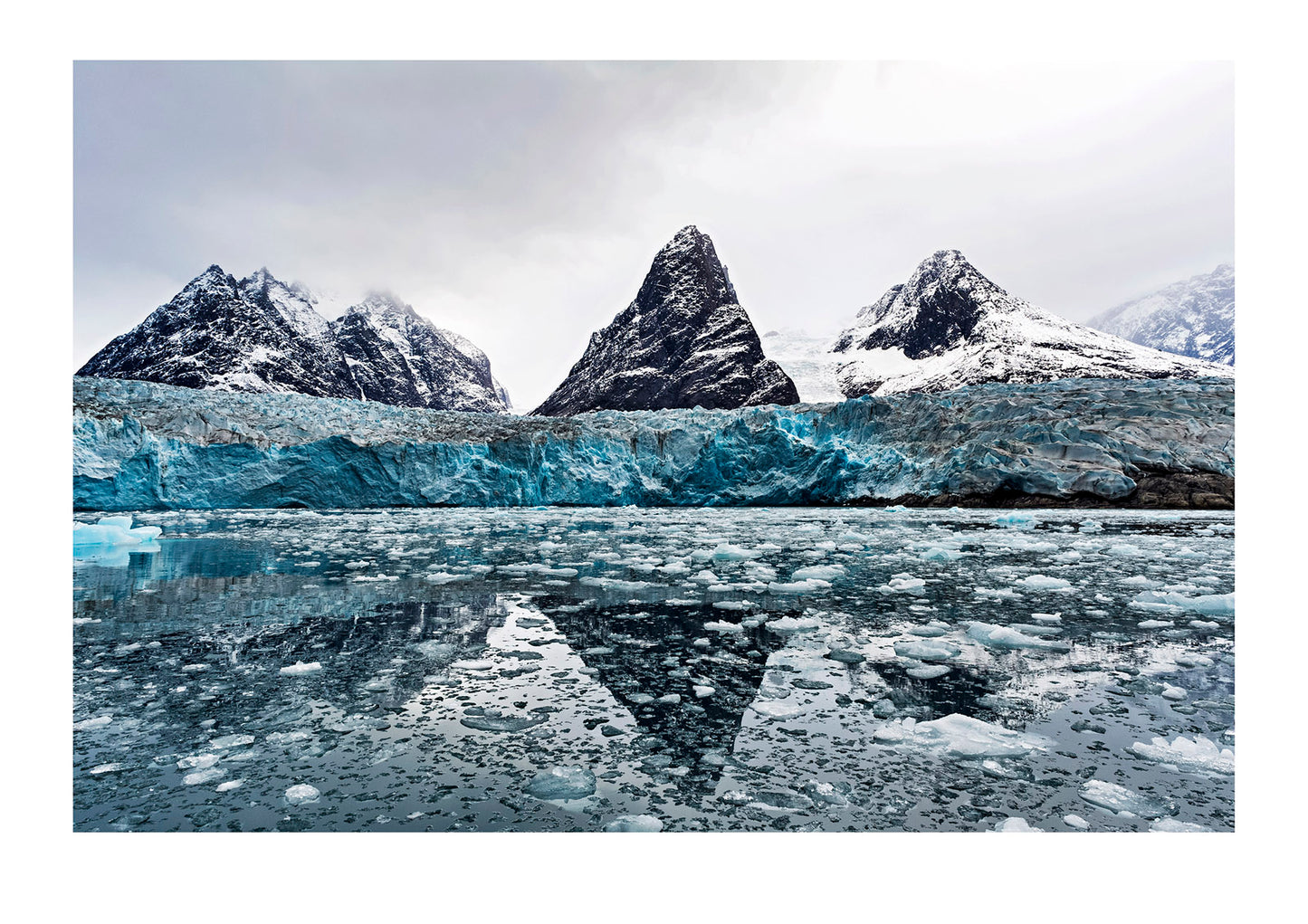 Greenland is a tortured landscape of rock and ice. The weather is changing here though. It is getting warmer. Glacier heads are contracting; freshwater ice shelves reserves are melting and the winter is getting shorter. Eternity Fjord, Greenland.