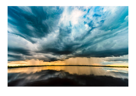 A torrential downpour from a rainstorm over a flooded wetland.
 Zarafa Camp, Zibadianja Lagoon, Savute Channel, Linyanti, Botswana.

