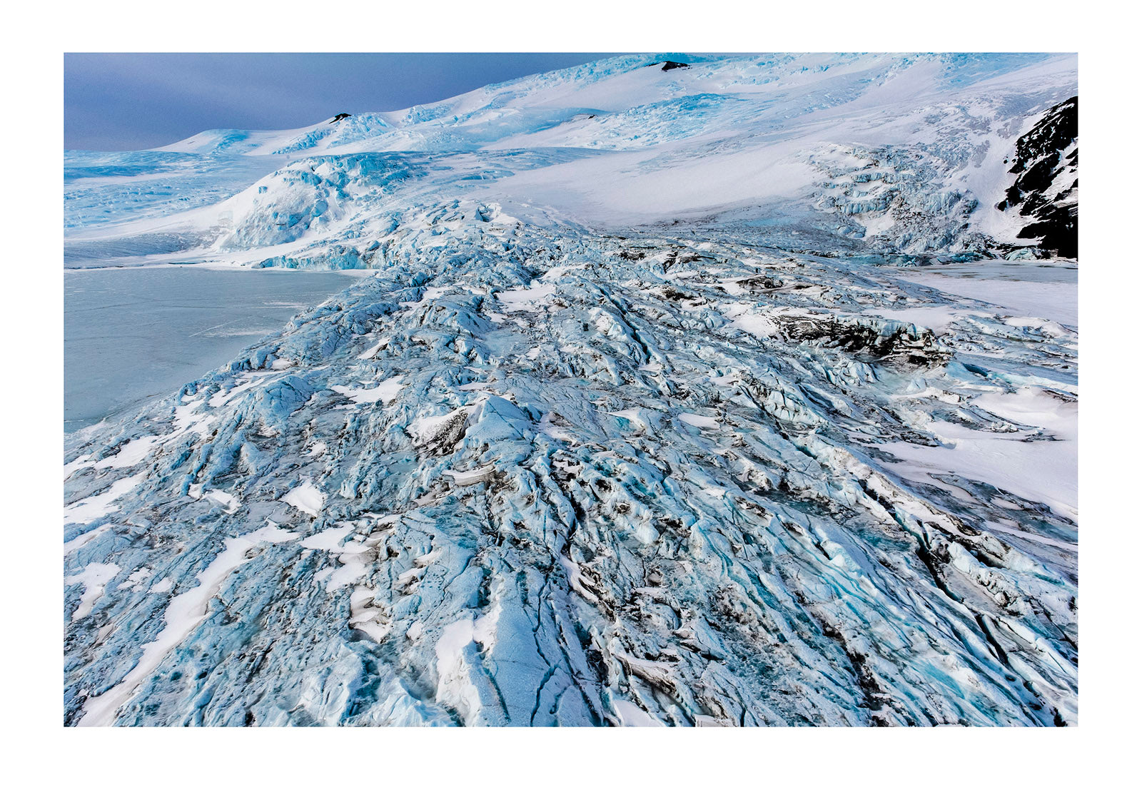 The fractured and tortured ice tongue of the Mt Erebus Glacier sweeps off the slopes of the active volcano. Pakaru Icefalls, South Bay, Ross Island, Antarctica.