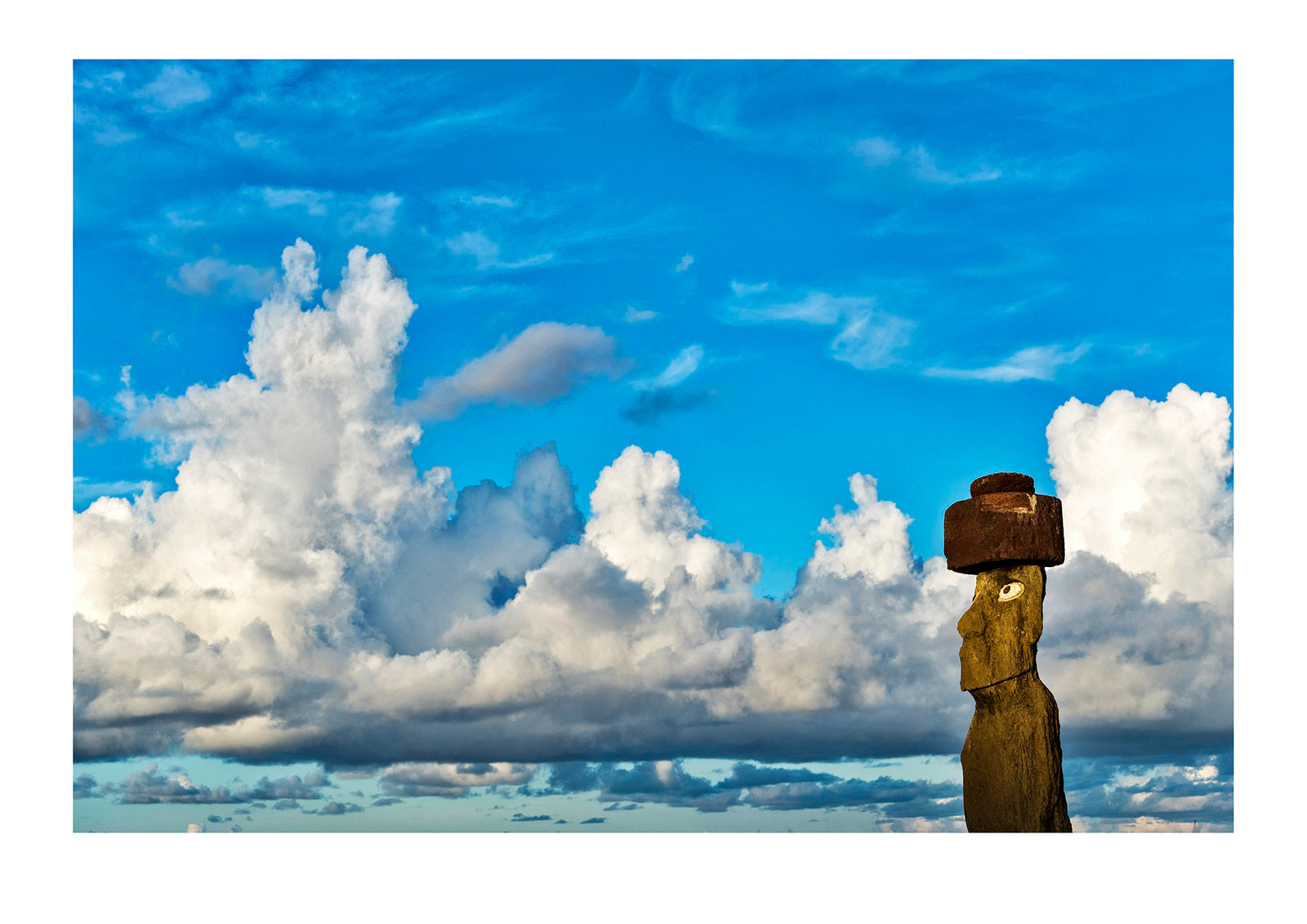 An ancient stone Moai statue greets the dawn on Rapa Nui, the worlds most remotely inhabited island. This island is also known as Easter Island and suffered envisronmental collapse at the hands of humanity. Rapa Nui, Easter Island, Chile.