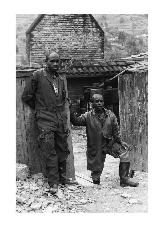 Labourers resting at the factory where they operate a smelter.  Rwanda. 