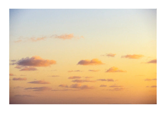 Light, fluffy pastel sunset storm clouds float over a tropical ocean. Coral Sea Island Territory, Australia.